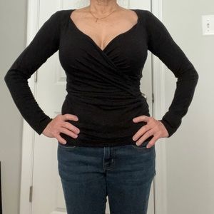 Perfect for the holidays, black fitted sweater with slight metallic accents.